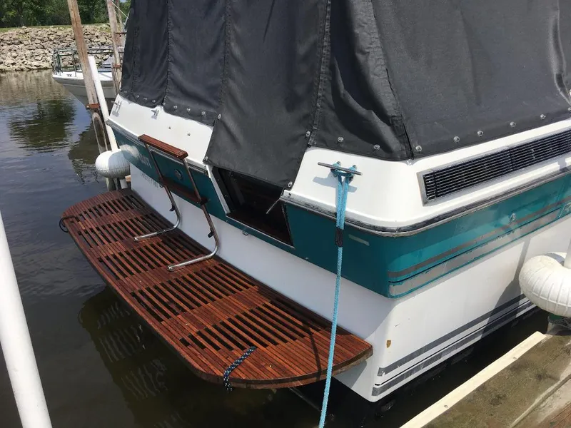 Slide: The Image of 1989 Regal Commodore 360 boat with wooden swim platform, docked in marina. - 4
