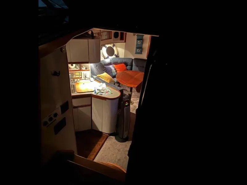 Slide: The Image of Cozy interior of 1989 Regal Commodore 360 yacht with kitchenette and seating area. - 7