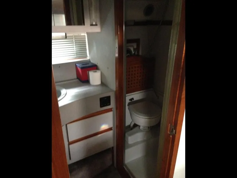 Slide: The Image of 1989 Regal Commodore 360 bathroom interior with toilet, sink, and storage cabinets. - 8