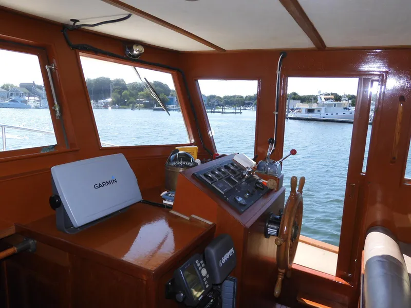 Slide: The Image of Interior of 1985 Sundowner Tug 30 with navigation equipment and scenic water view. - 5