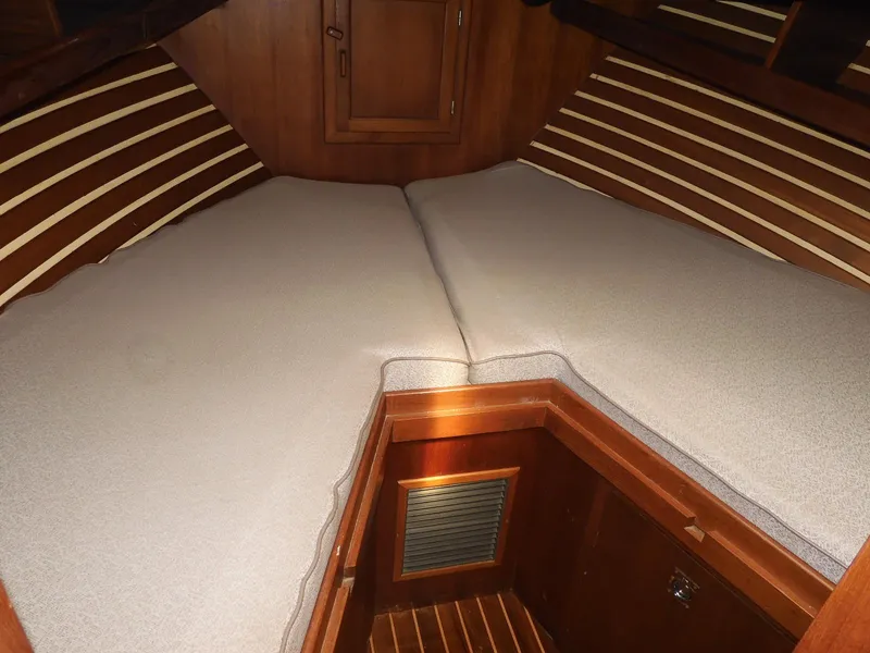 Slide: The Image of 1985 Sundowner Tug 30 interior cabin with V-berth and wooden finish. - 8
