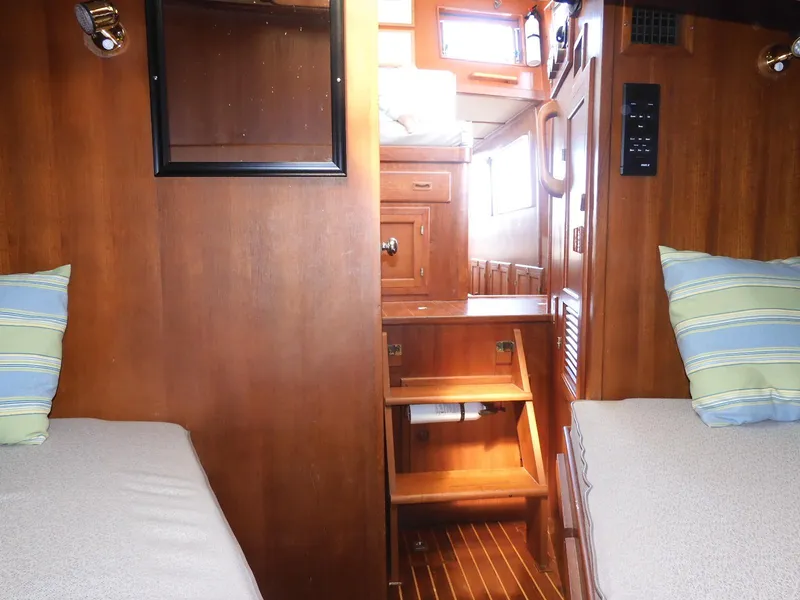 Slide: The Image of Interior of 1985 Sundowner Tug 30 with wooden finish and twin beds. - 9