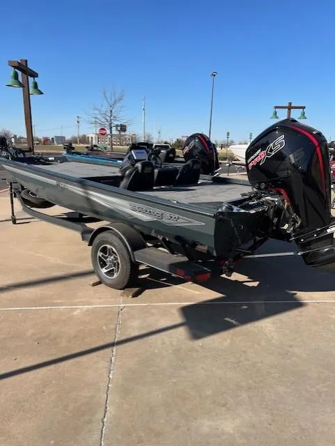 Slide: The Image of 2024 Ranger RT188 boat with powerful outboard motor, parked on a trailer in a sunny lot. - 3