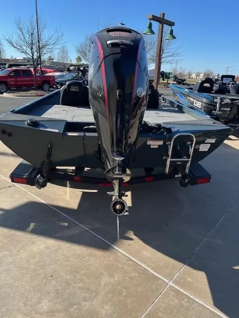 Slide: The Image of 2024 Ranger RT188 boat with outboard motor, parked outdoors on a sunny day. - 4