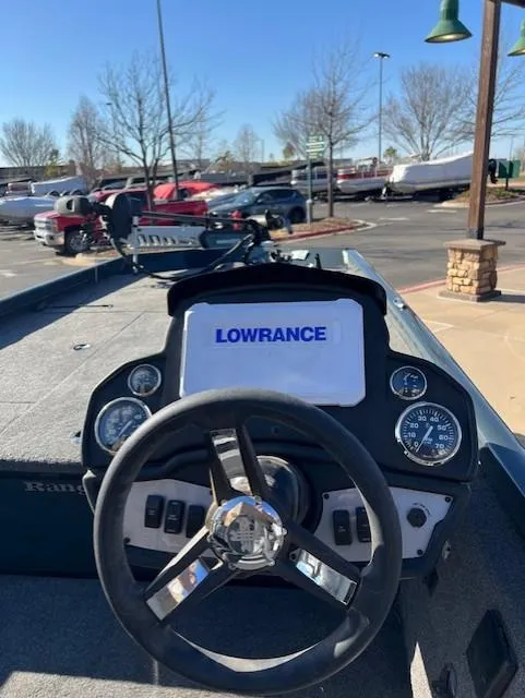 Slide: The Image of 2024 Ranger RT188 boat dashboard with Lowrance display in a parking lot. - 5