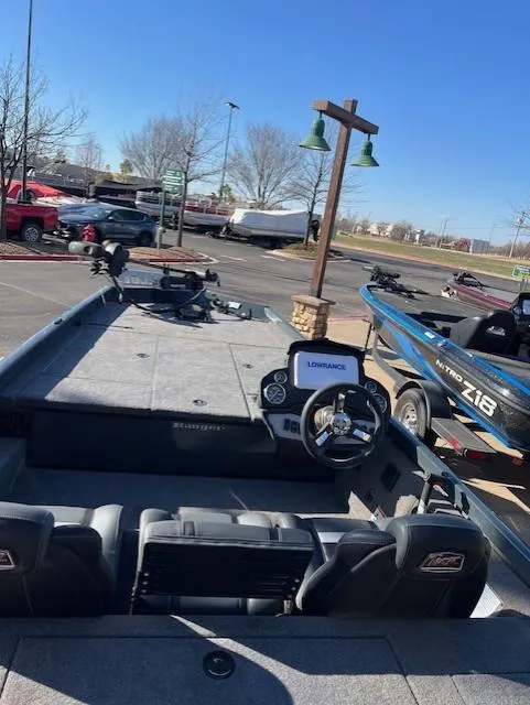 Slide: The Image of 2024 Ranger RT188 boat interior with steering wheel and Lowrance electronics, parked outdoors. - 7