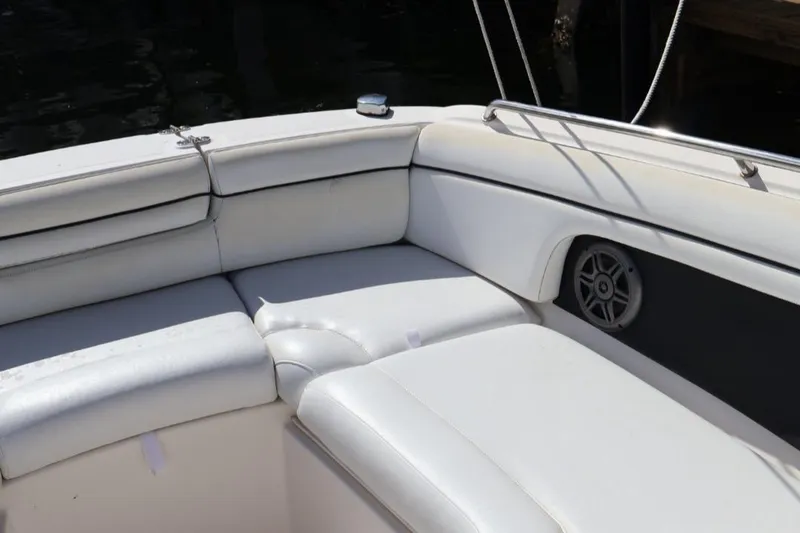 Slide: The Image of 2015 Sea Ray 270 Sundeck Outboard, white cushioned seating area with speaker. - 17