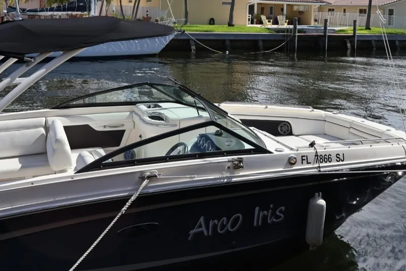 Slide: The Image of 2015 Sea Ray 270 Sundeck Outboard boat docked on calm water. - 2