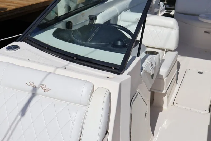 Slide: The Image of 2015 Sea Ray 270 Sundeck Outboard, white interior, steering wheel, and seating area. - 20