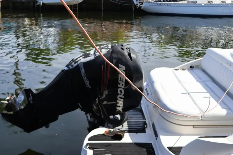 Slide: The Image of 2015 Sea Ray 270 Sundeck Outboard with Mercury engine, docked by the water. - 24