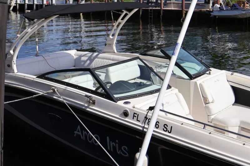 Slide: The Image of 2015 Sea Ray 270 Sundeck Outboard boat docked on calm water. - 26