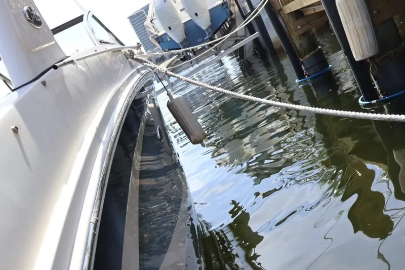 Slide: The Image of 2015 Sea Ray 270 Sundeck Outboard docked, reflecting on calm water. - 28