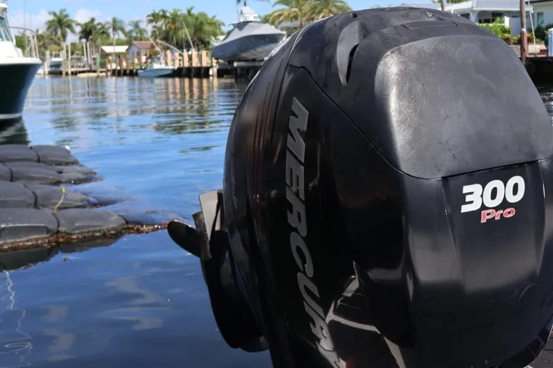 Slide: The Image of Outboard motor on a 2015 Sea Ray 270 Sundeck, docked by a scenic waterfront. - 30