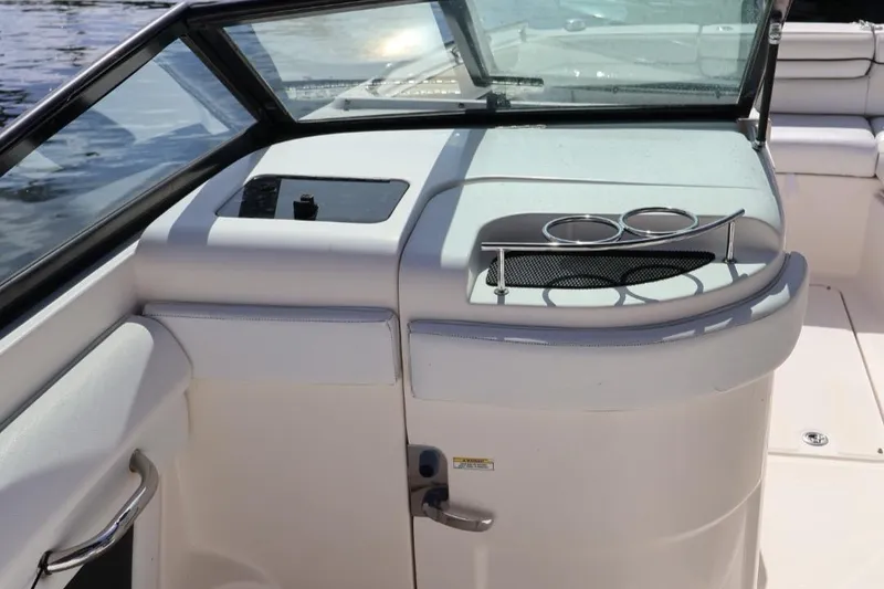 Slide: The Image of 2015 Sea Ray 270 Sundeck Outboard interior with cup holders and seating area. - 9