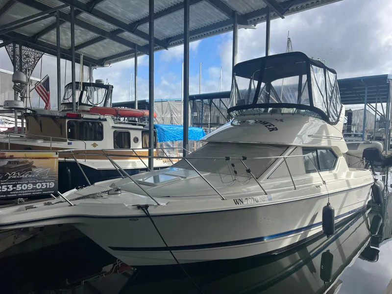 Slide: The Image of 2004 Bayliner 288 Ciara Classic Command Bridge docked in a covered marina. - 0