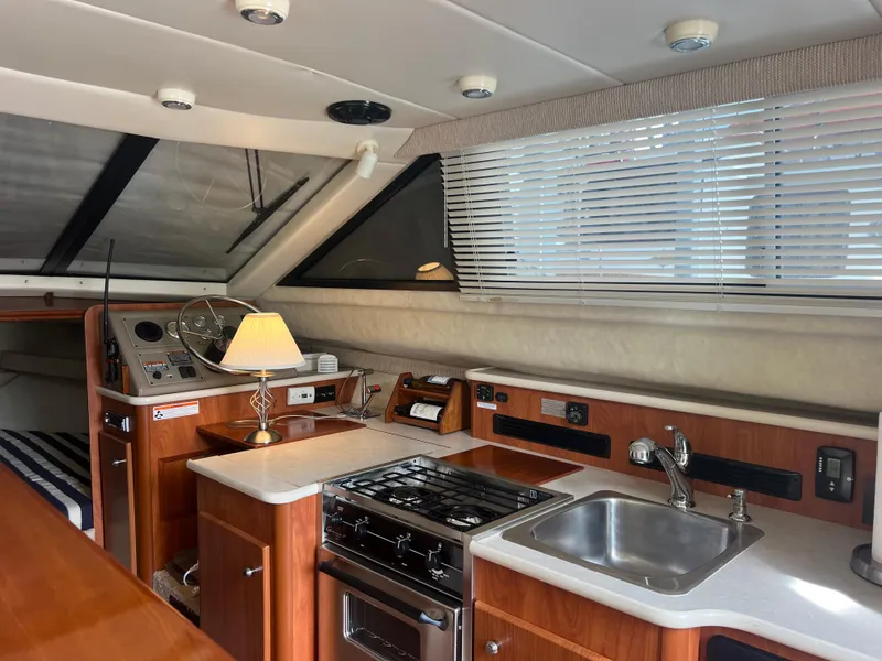 Slide: The Image of 2004 Bayliner 288 Ciara Classic Command Bridge interior with kitchen and helm. - 14