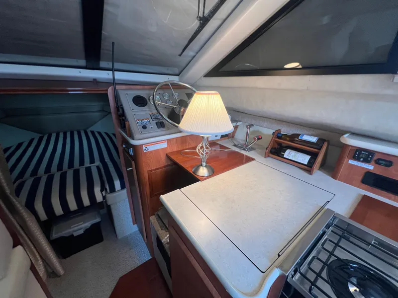 Slide: The Image of 2004 Bayliner 288 Ciara Classic Command Bridge interior with cozy cabin and kitchenette. - 15