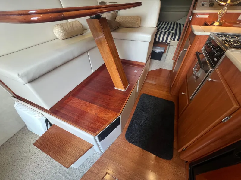 Slide: The Image of 2004 Bayliner 288 Ciara Classic Command Bridge interior with wood accents and seating area. - 22