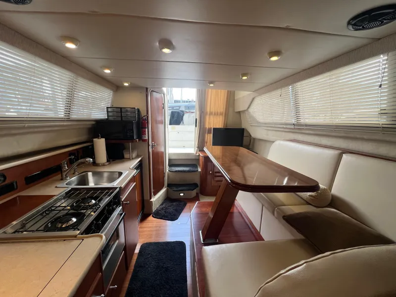 Slide: The Image of Interior of 2004 Bayliner 288 Ciara Classic Command Bridge with kitchen and dining area. - 26