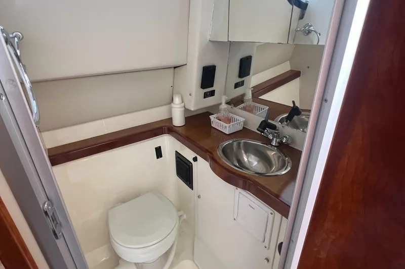 Slide: The Image of 2004 Bayliner 288 Ciara Classic Command Bridge bathroom with sink and toilet. - 27