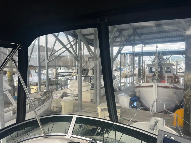 Slide: The Image of 2004 Bayliner 288 Ciara Classic Command Bridge in a marina with other boats. - 31