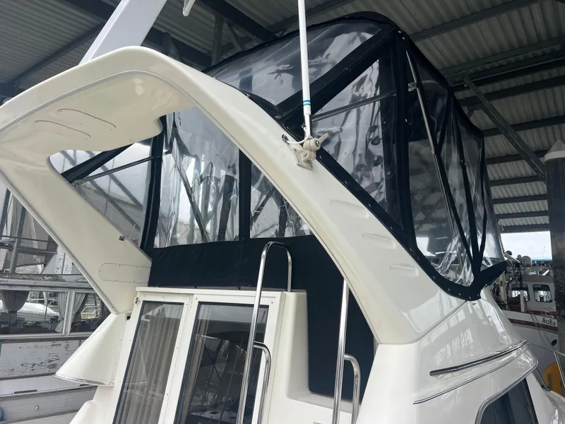 Slide: The Image of 2004 Bayliner 288 Ciara Classic Command Bridge with enclosed upper deck under a metal roof. - 32