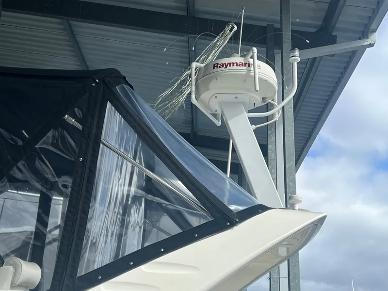 Slide: The Image of 2004 Bayliner 288 Ciara Classic Command Bridge with Raymarine radar under a covered dock. - 33