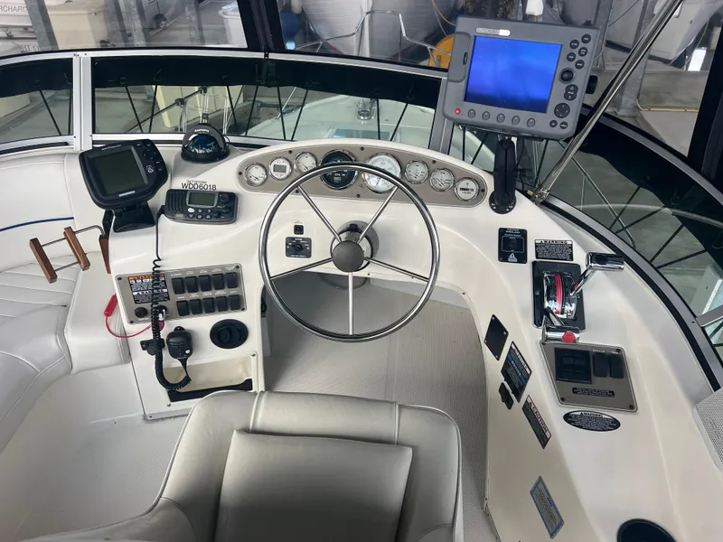 Slide: The Image of 2004 Bayliner 288 Ciara Classic Command Bridge cockpit with steering wheel and navigation equipment. - 38