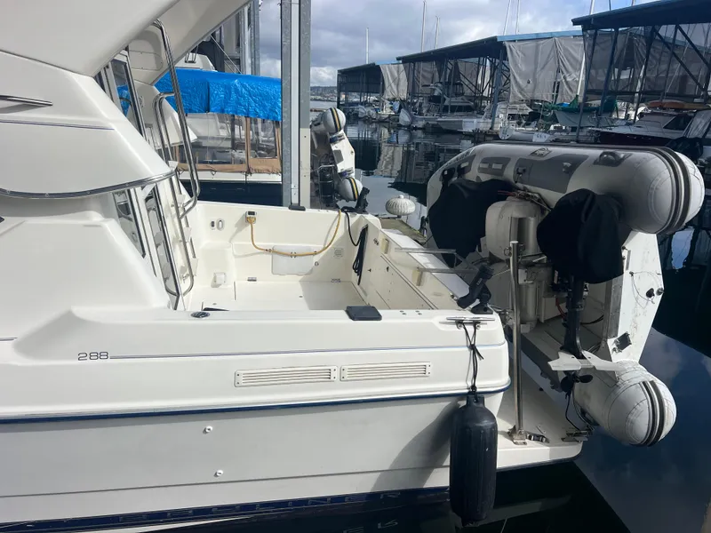 Slide: The Image of 2004 Bayliner 288 Ciara Classic Command Bridge docked at marina with inflatable boat. - 41