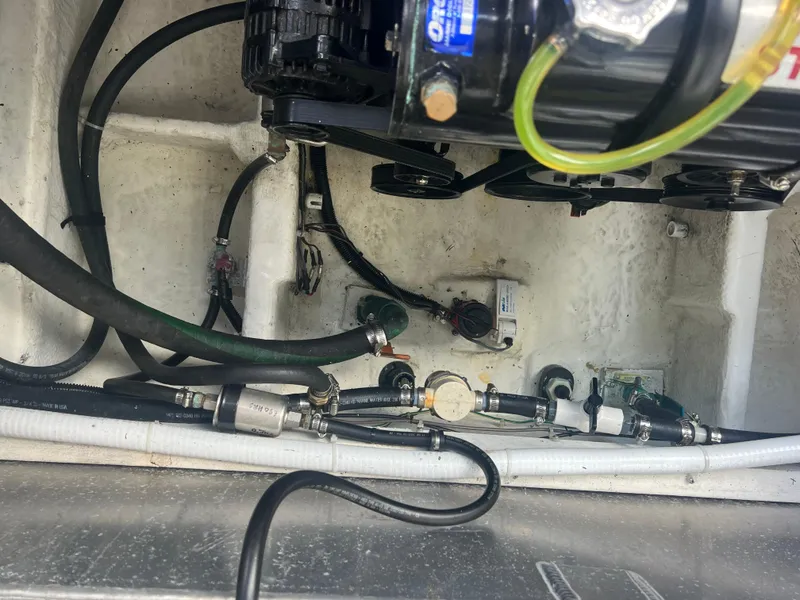 Slide: The Image of Engine compartment of 2004 Bayliner 288 Ciara Classic Command Bridge with visible hoses and components. - 42