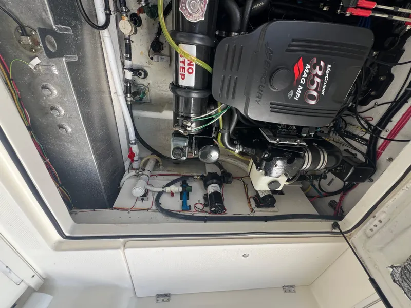 Slide: The Image of Engine compartment of 2004 Bayliner 288 Ciara Classic Command Bridge, showcasing MerCruiser 350 MPI engine. - 44