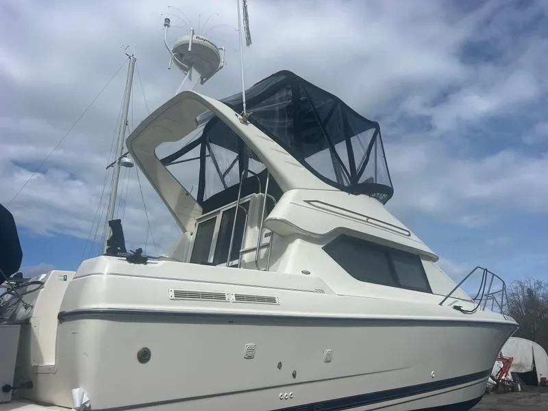 Slide: The Image of 2004 Bayliner 2858 Ciara Classic Command Bridge under cloudy sky. - 48