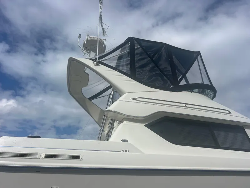 Slide: The Image of 2004 Bayliner 2858 Ciara Classic Command Bridge against a cloudy sky. - 6