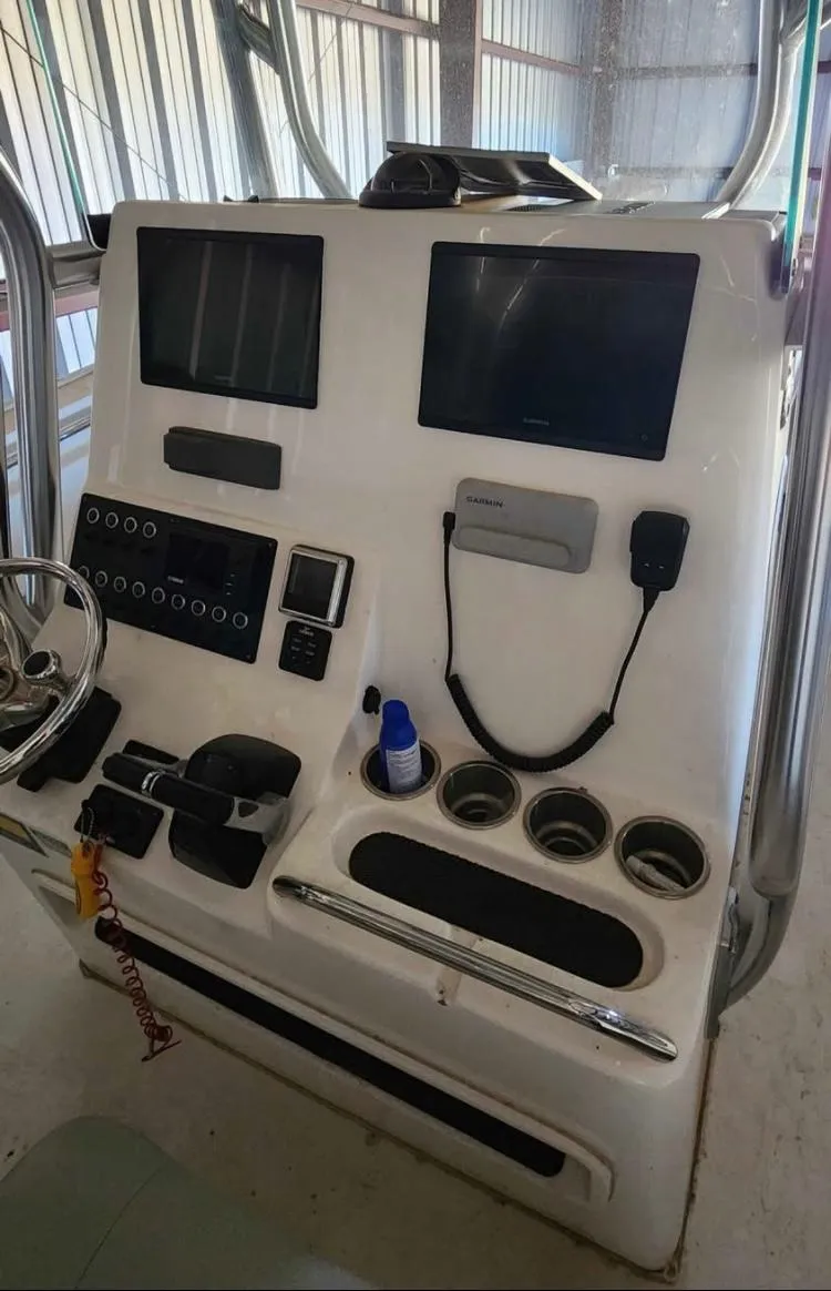 Slide: The Image of 2020 Cape Horn 27 XS boat console with navigation screens and controls. - 6