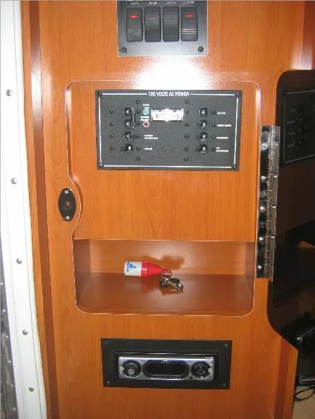 Slide: The Image of 2003 Four Winns 268 Vista control panel with switches and storage compartment. - 11