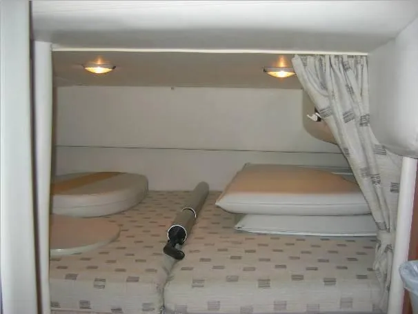 Slide: The Image of Interior cabin of 2003 Four Winns 268 Vista boat with cozy bedding. - 12