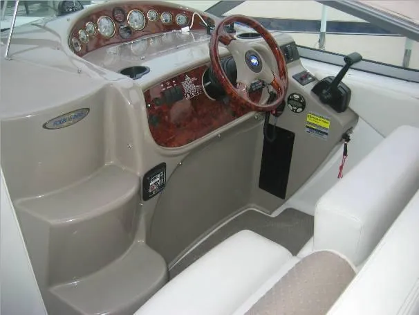 Slide: The Image of 2003 Four Winns 268 Vista boat interior with steering wheel and control panel. - 2