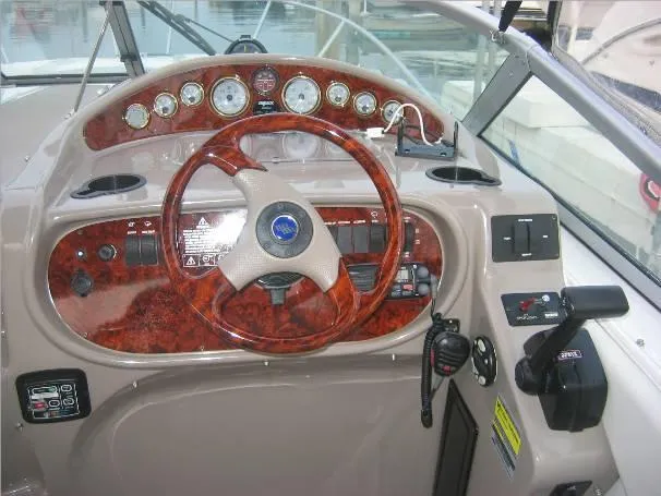 Slide: The Image of 2003 Four Winns 268 Vista boat dashboard with woodgrain steering wheel and instrument panel. - 4
