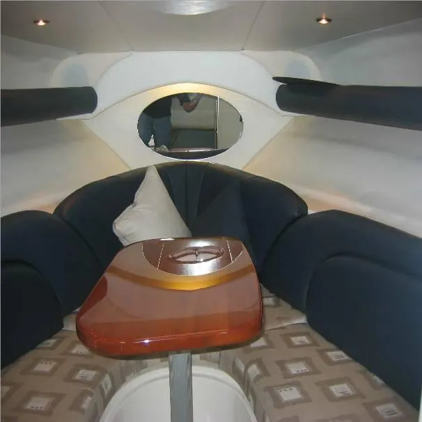 Slide: The Image of Interior of 2003 Four Winns 268 Vista boat with cozy seating and wooden table. - 7