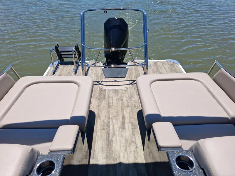 Slide: The Image of Crest Caribbean 230 SLRC 2025 with luxurious loungers and outboard motor. - 8
