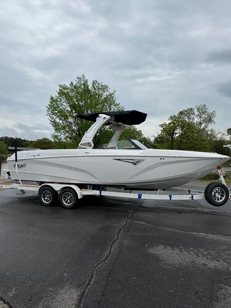 Slide: The Image of 2025 Tigé Z5 boat on trailer, parked outdoors under cloudy sky. - 1