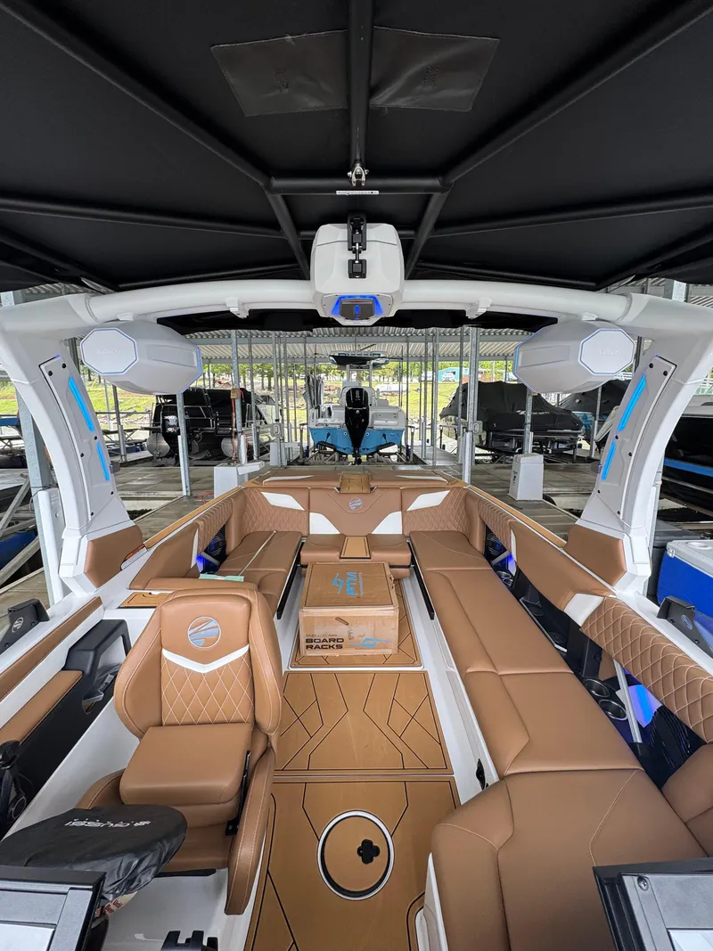 Slide: The Image of 2025 Tigé Z5 boat interior with luxurious brown seating and modern design features. - 18