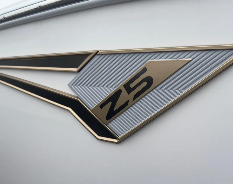 Slide: The Image of Close-up of 2025 Tigé Z5 boat emblem with sleek design details. - 2