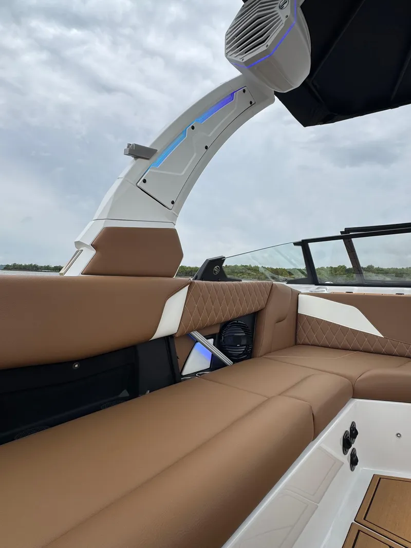 Slide: The Image of 2025 Tigé Z5 boat interior with brown leather seating and modern speaker system. - 4