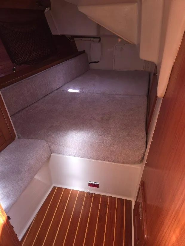 Slide: The Image of 1997 Catalina 42 MkII interior cabin with cushioned seating and wooden flooring. - 46