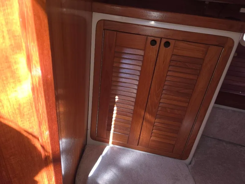 Slide: The Image of Wooden cabinet doors inside a 1997 Catalina 42 MkII sailboat interior. - 47