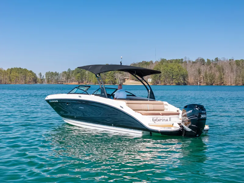 Slide: The Image of 2017 Sea Ray SDX 270 Outboard boat on a lake, featuring a sleek design and canopy. - 1