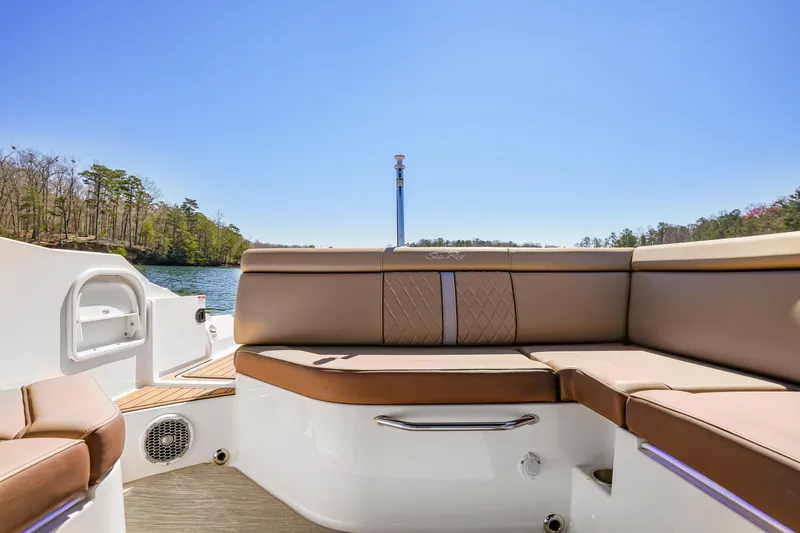 Slide: The Image of 2017 Sea Ray SDX 270 Outboard boat interior with tan seating and scenic lake view. - 10