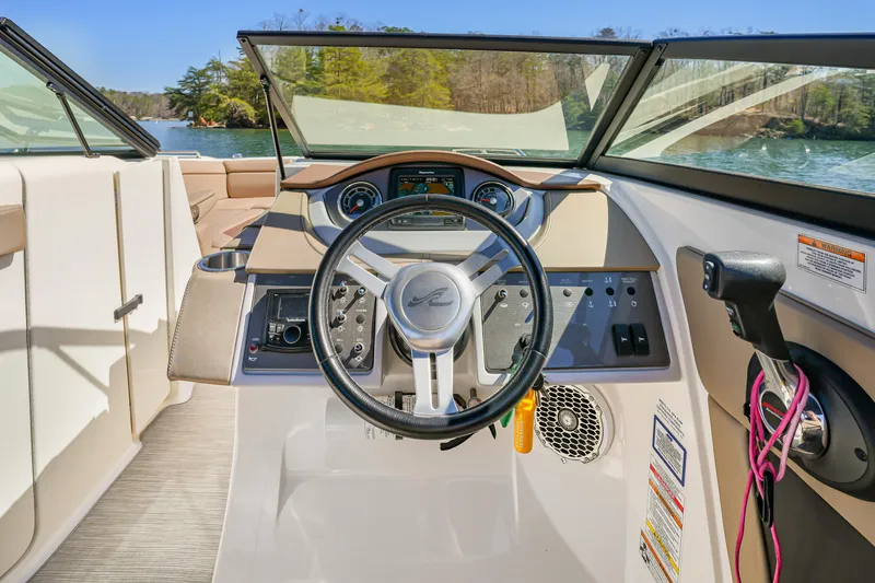 Slide: The Image of 2017 Sea Ray SDX 270 Outboard boat cockpit with steering wheel and dashboard controls. - 13