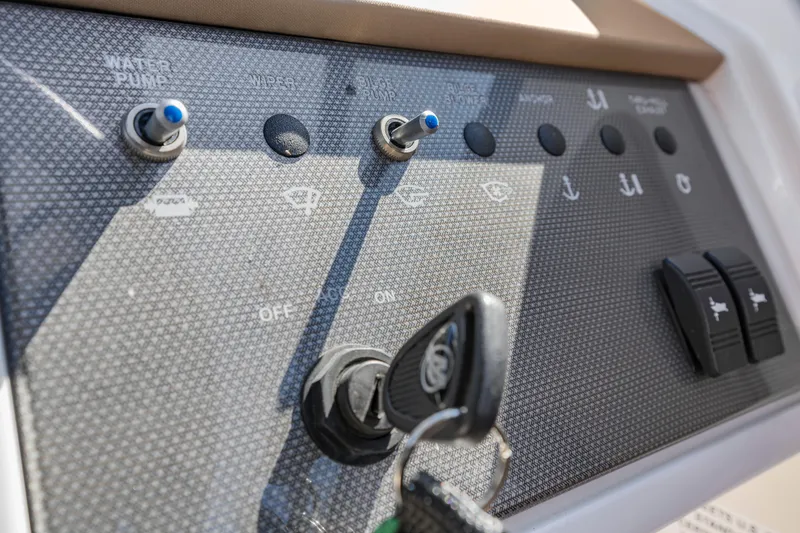 Slide: The Image of Control panel of 2017 Sea Ray SDX 270 Outboard boat with switches and key ignition. - 17